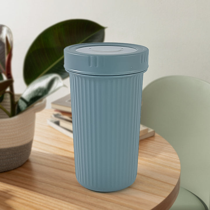 Superior eMart blue 500ml insulated travel cup with ribbed design placed on wooden table