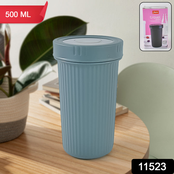 500ml insulated travel cup in muted blue with ribbed design on wooden table by green plant