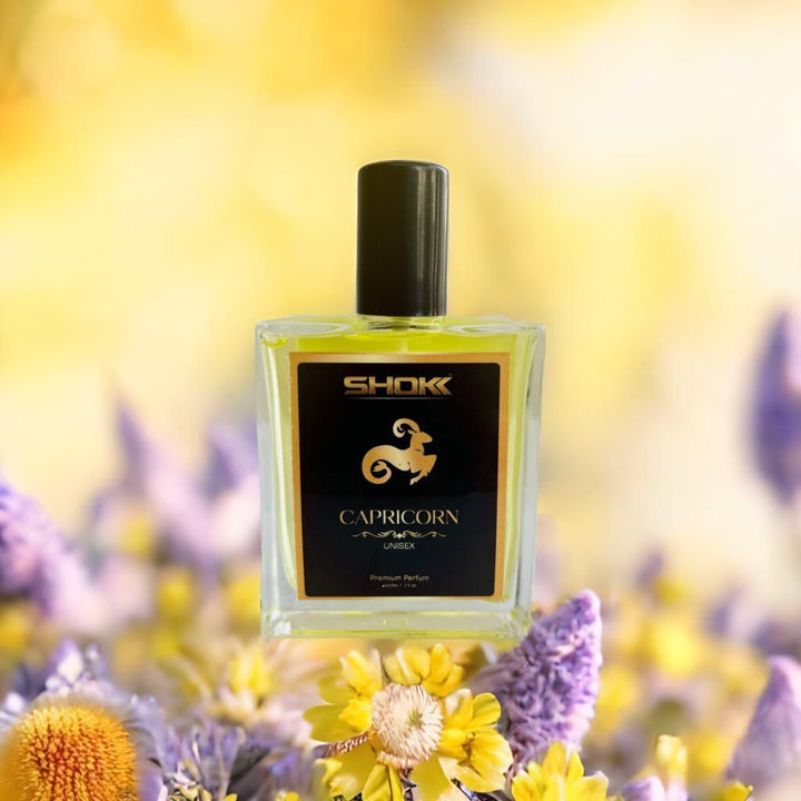 Capricorn Zodiac Unisex Perfum 50ml by Superior eMart in a clear glass bottle with black cap on a floral background