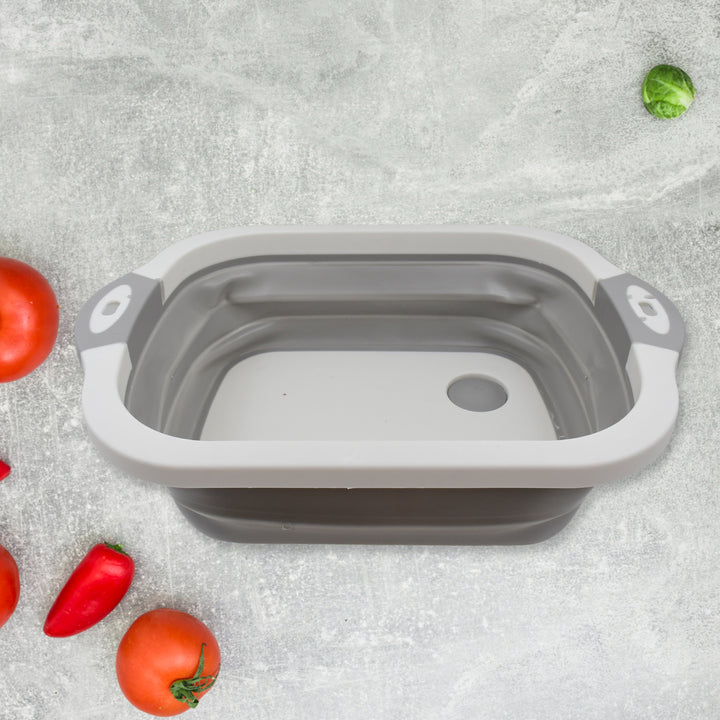 Collapsible cutting board with a dish tub basket