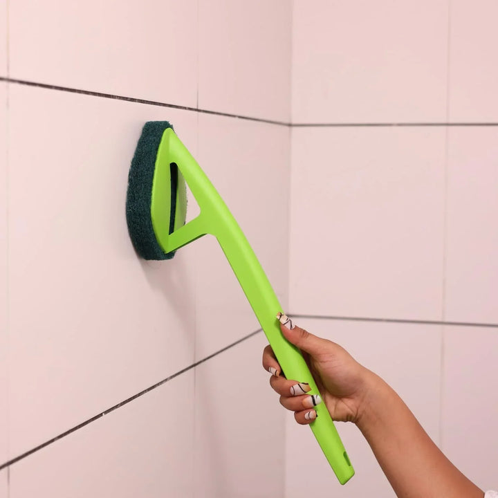 Ergonomic bathroom cleaning brush with a green handle for effective tile cleaning