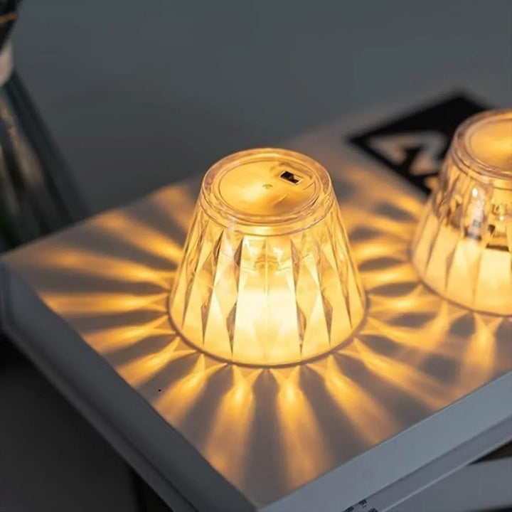 Cup shape crystal lamp with warm glow casting beautiful patterns on the surface