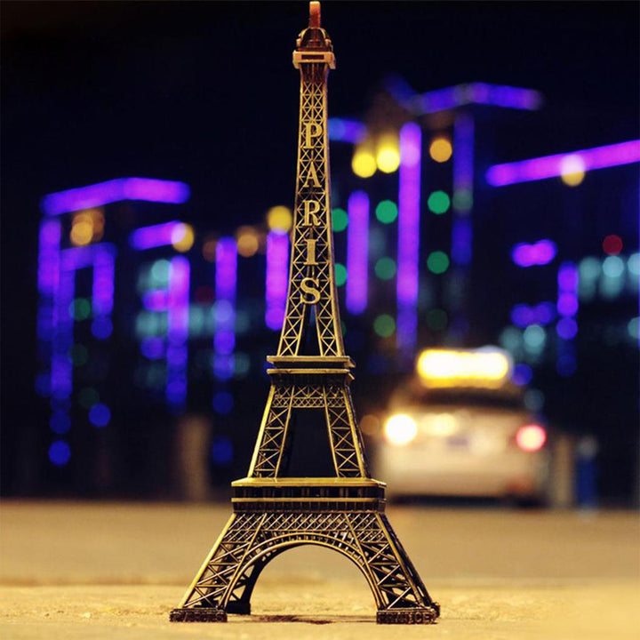 Eiffel Tower metal statue in a vibrant cityscape with colorful lights at night