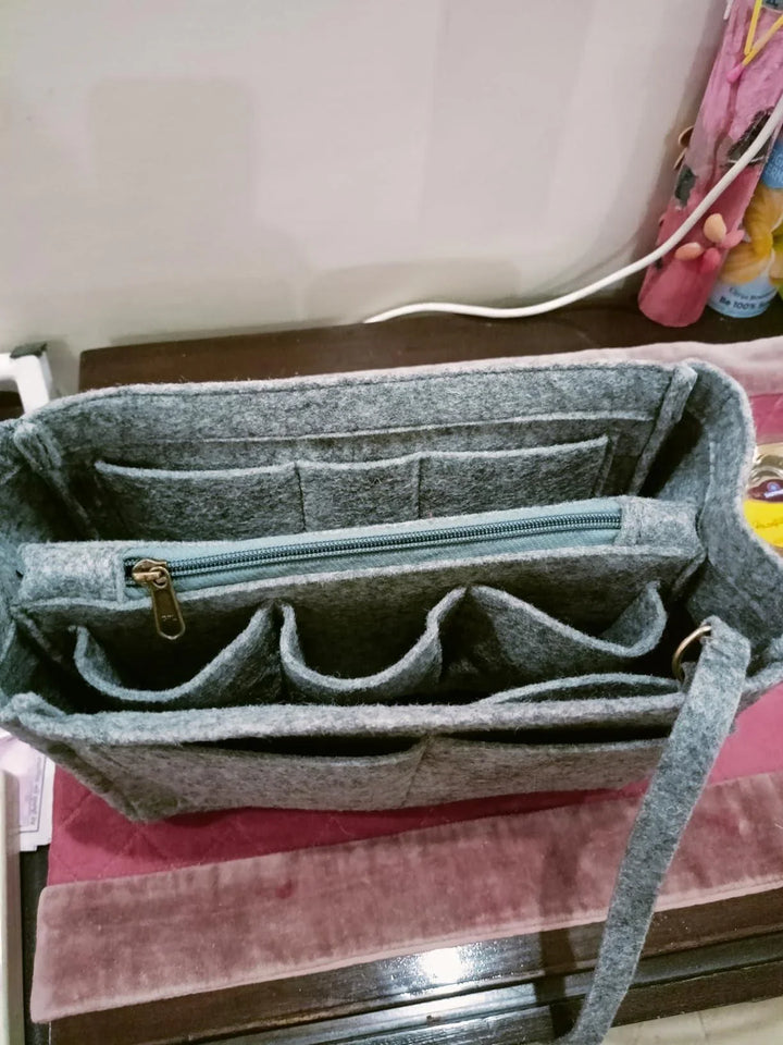 Gray felt purse organizer with multiple compartments and a zipper for maximum storage efficiency