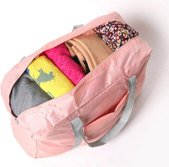 Pink Foldable Duffel Bag with various folded clothes inside for travel and storage