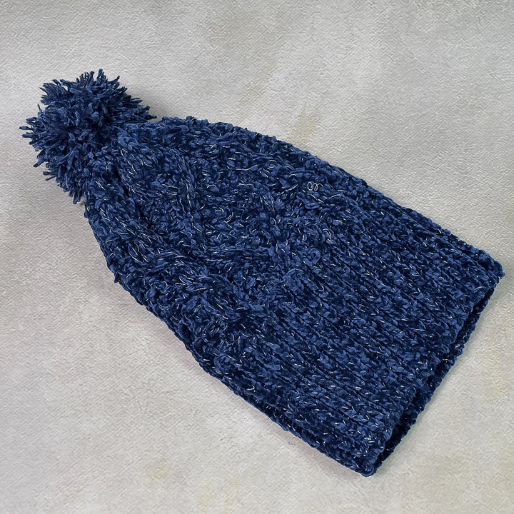 Navy girls winter cap cozy with a soft texture and fluffy pom pom for warmth and style