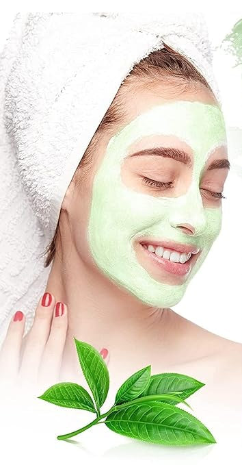 Green tea clay mask stick applied on woman’s face next to green stick container and tea leaves