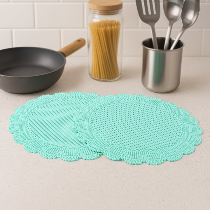 Set of two heat resistant silicone mats in mint green for kitchen surfaces and cookware protection