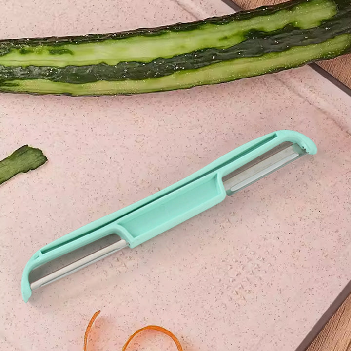 Superior eMart double side potato peeler with light blue handle on cutting board with peeled cucumber