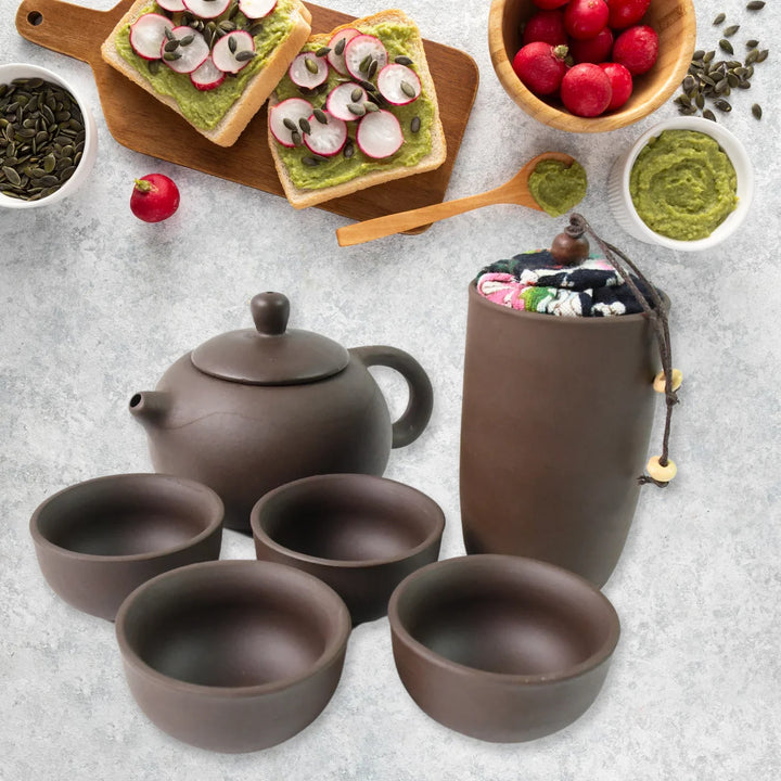 Kung Fu tea set portable with a teapot, four bowls, and a floral carrying pouch for tea enthusiasts