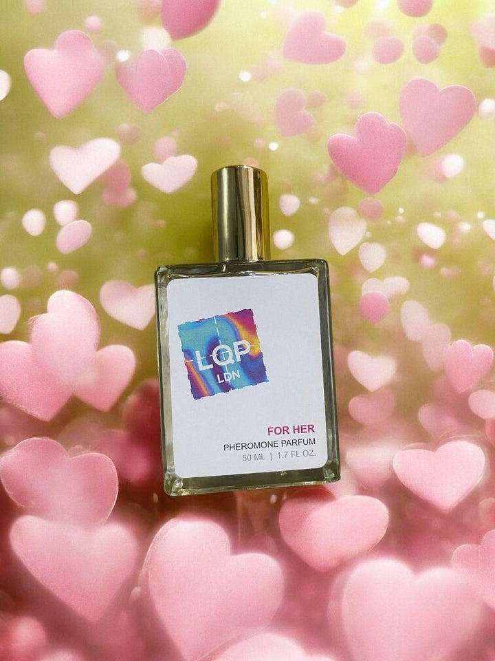 Pheromone perfume for women 50 ml bottle with gold cap surrounded by pink heart shapes
