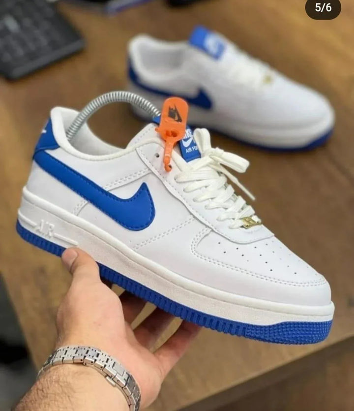 Nike Air Force 1 men's casual shoes in white and blue with a hand holding them