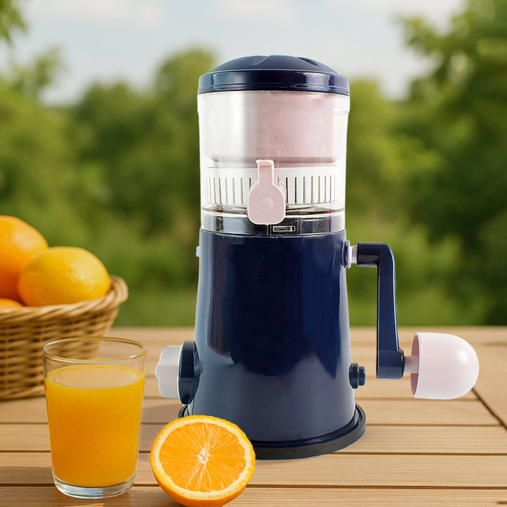 Manual hand juicer for fruits and vegetables in navy blue with a glass of orange juice and fresh oranges