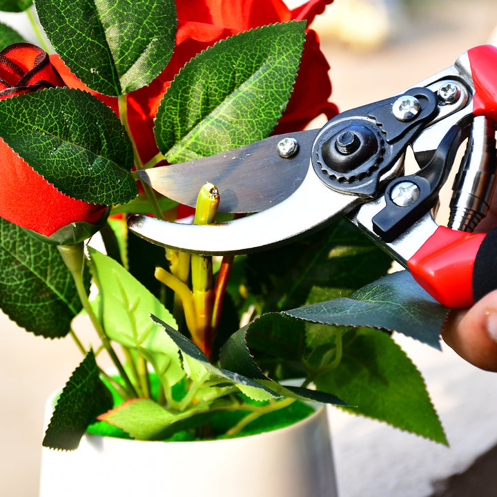 Red garden shears 21cm cutting through vibrant roses for precise gardening tasks