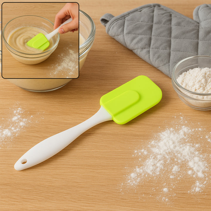 Superior eMart green and white silicone cooking spatula on wooden surface with flour and oven mitts