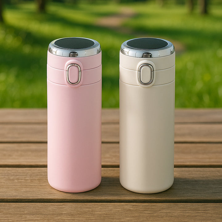 Smart insulated water bottle in pink and cream colors for maintaining beverage temperature outdoors