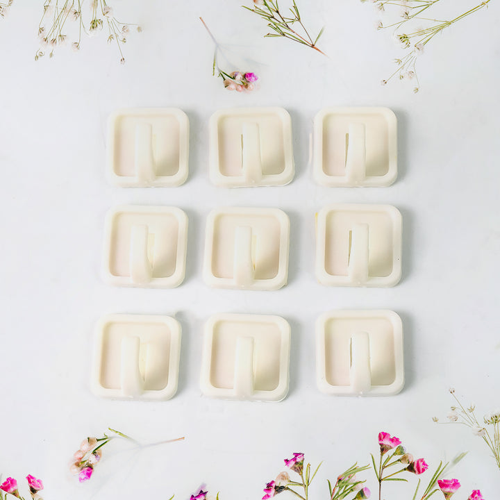 Set of strong adhesive wall hooks in beige, ideal for hanging items in any home or kitchen