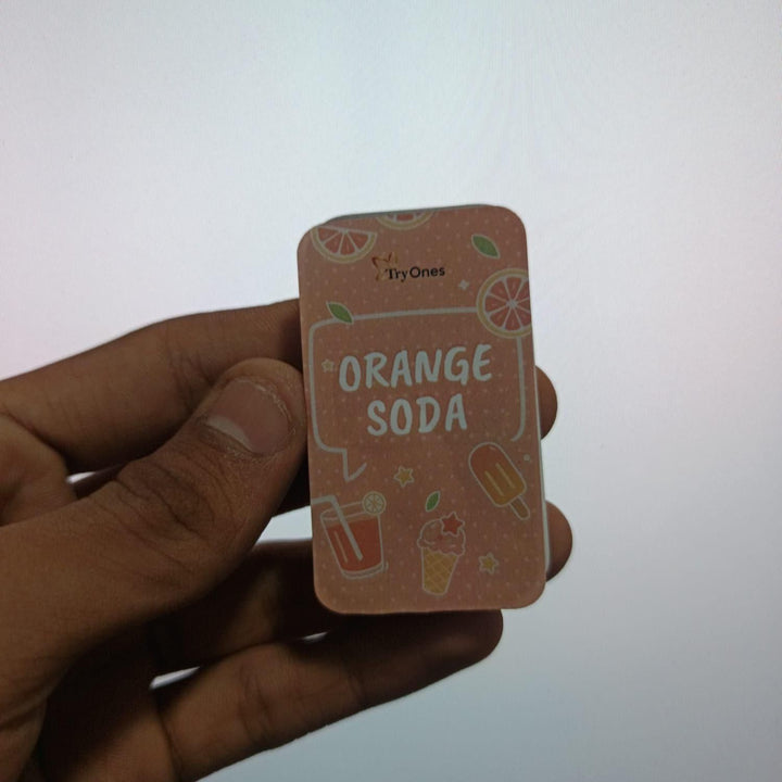 Orange Soda Solid Perfume 20 gm Pack of 2 in compact rectangular container held in hand