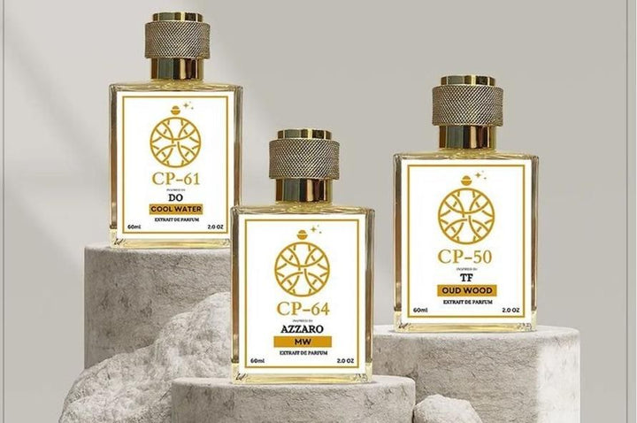 Three perfume bottles labeled CP-61 DO Cool Water CP-64 Azzaro and CP-50 TF Oud Wood displayed on stone stands with gold caps for CP - 53 Saauvage