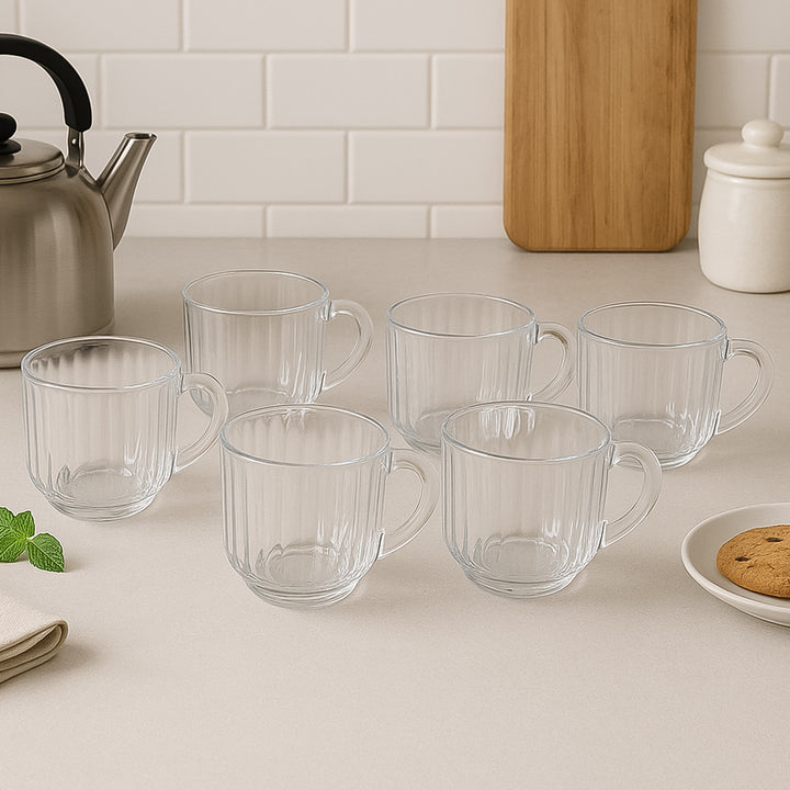 Set of six clear unbreakable plastic tea cups with handles displayed on kitchen counter