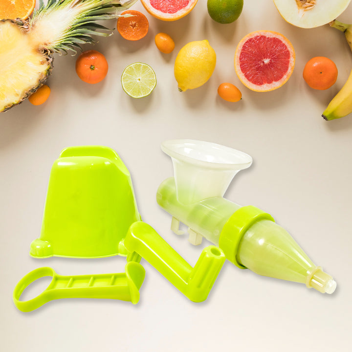 Manual fruit juicer in bright green color with fruit cutouts on a kitchen countertop