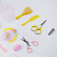 4-in-1 baby health care kit including nail clipper, brush, comb, and scissors for grooming and safety.