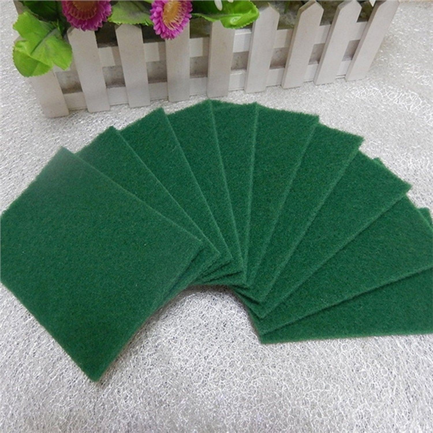 Set of 10 aqua green cleaning pads for scrubbing tasks.