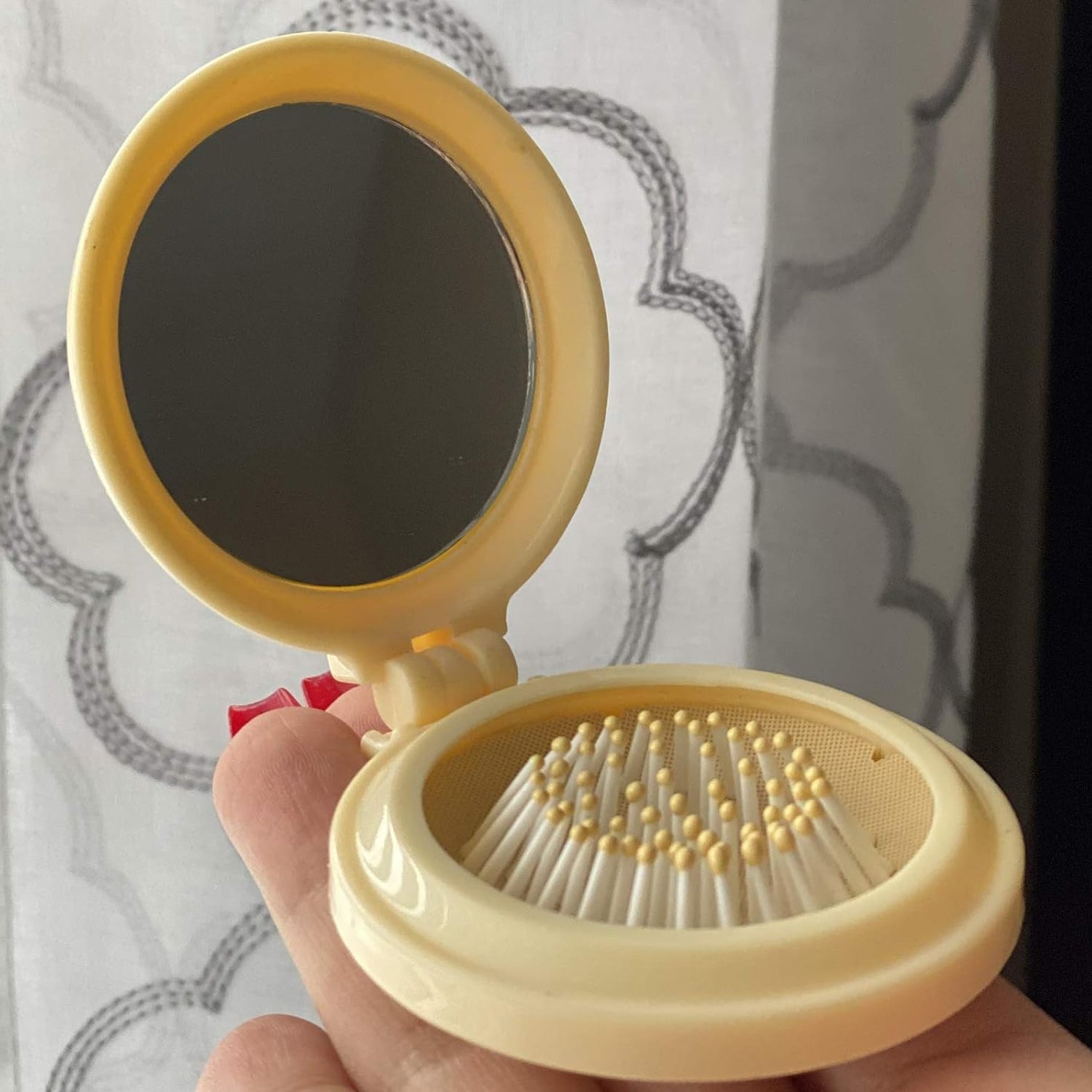 Mini folding hair brush with mirror, perfect for on-the-go use