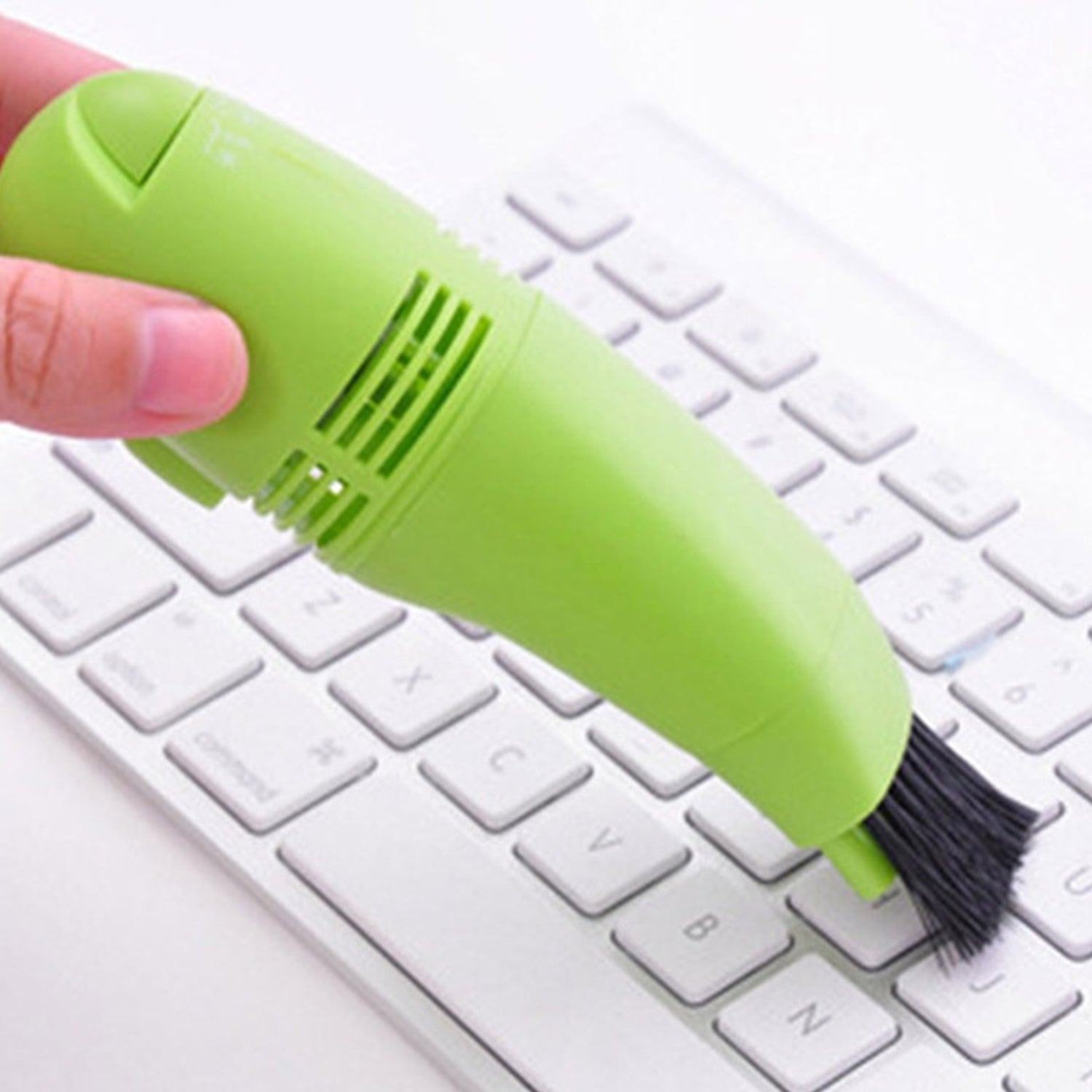 Compact and portable mini vacuum cleaner for targeted cleaning of electronic devices.