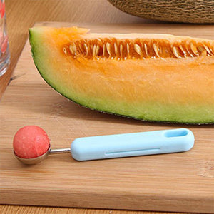 2-in-1 fruit peeler and baller next to melon slice for easy fruit preparation