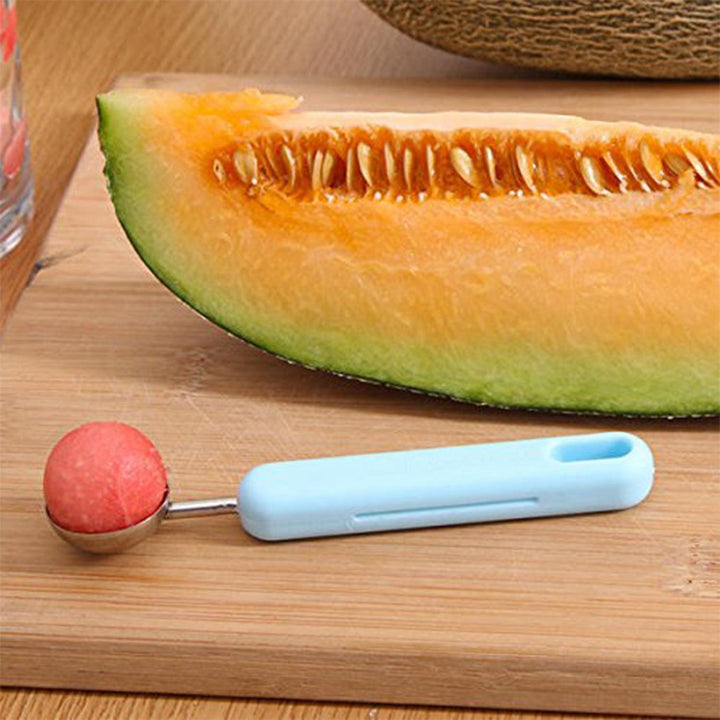 2-in-1 fruit peeler and baller next to melon slice for easy fruit preparation