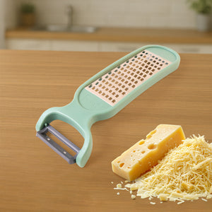 Superior eMart 2-in-1 vegetable grater peeler in mint green with cheese and grated vegetables beside it
