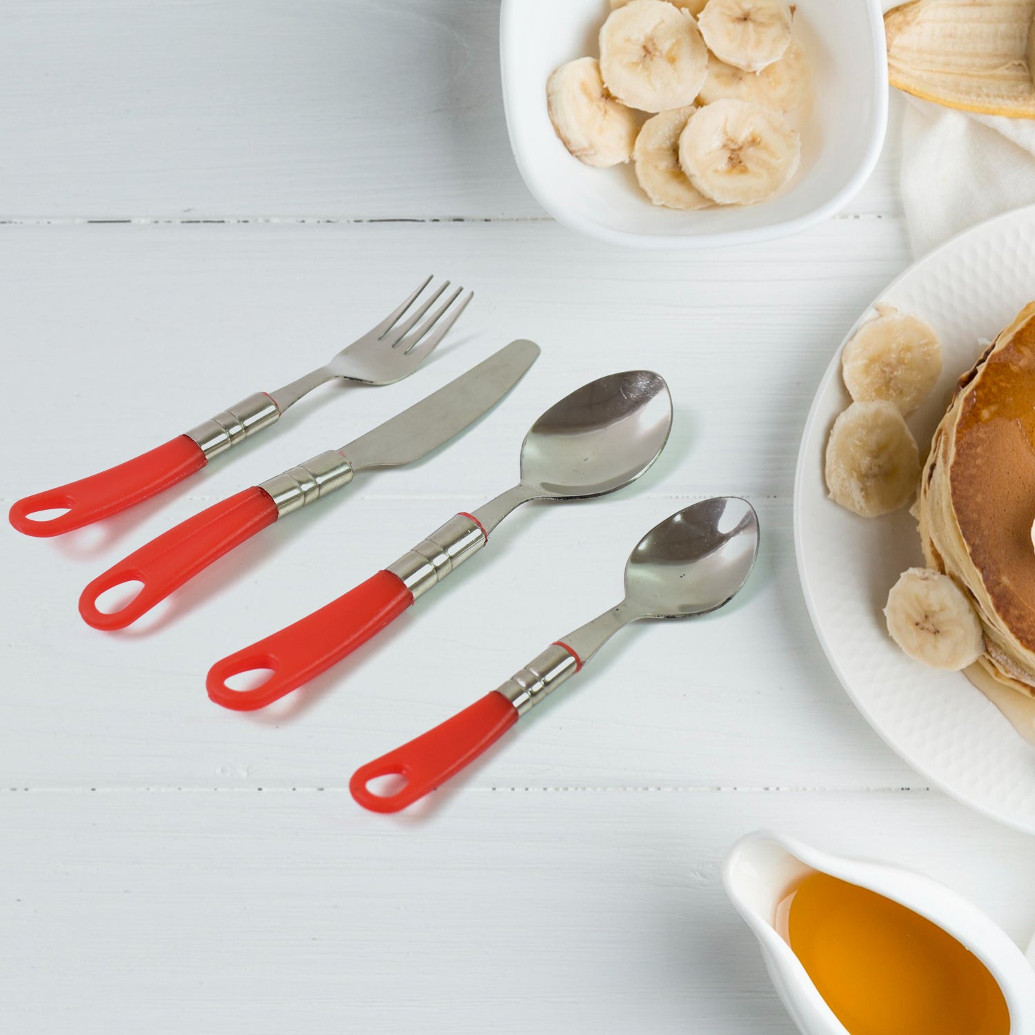 26-piece dining table cutlery set with red handles and stainless steel accents