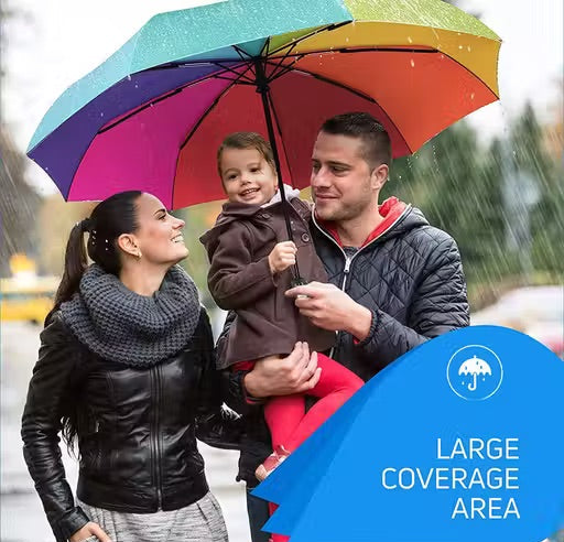 A family of four sharing a large, vibrant rainbow umbrella in the rain. The woman on the left wears a black leather jacket and a thick gray knit scarf, while the man on the right wears a dark quilted jacket.