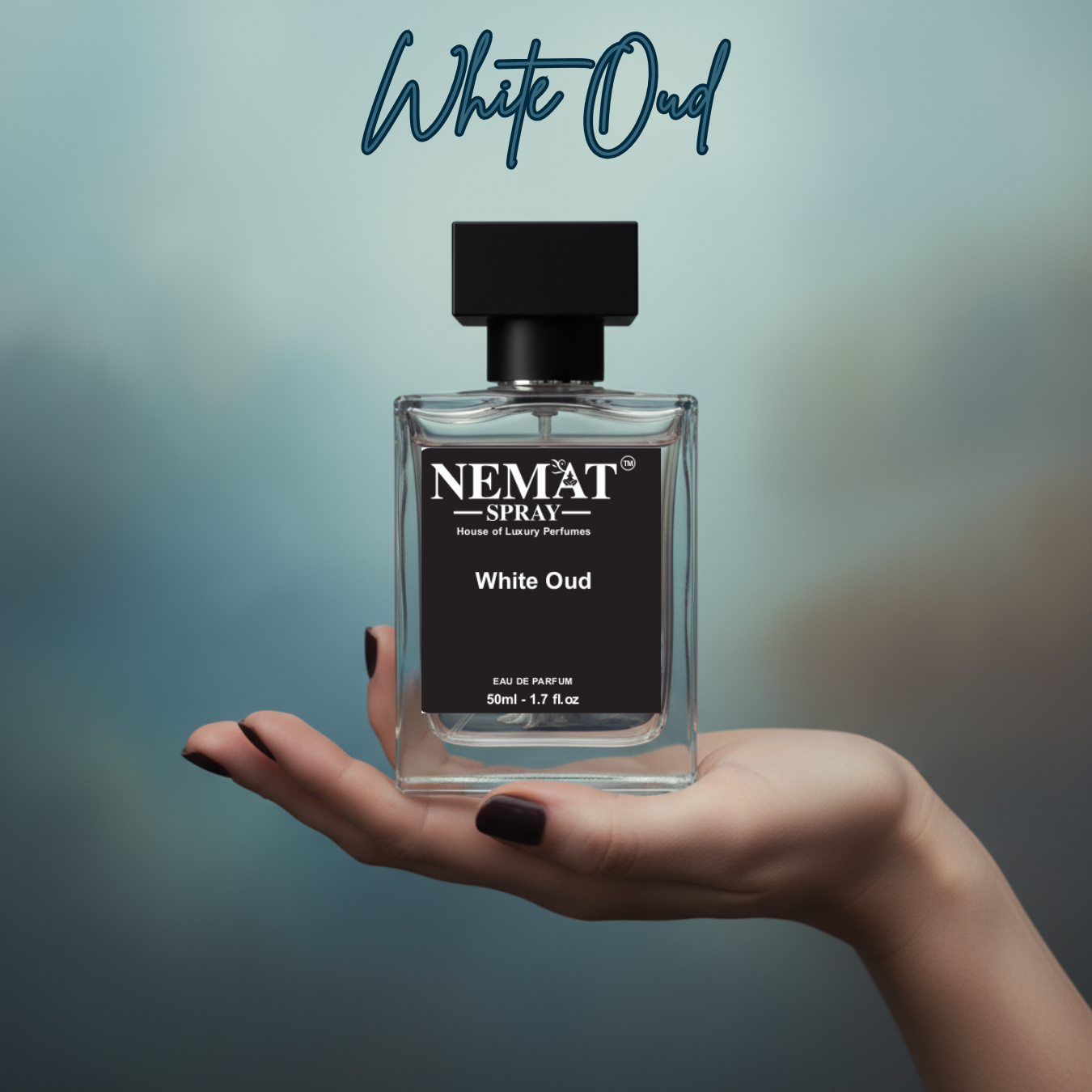 Hand holding Nemat White Oud 1.7 fl.oz spray perfume in a clear glass bottle with a black label and square cap.