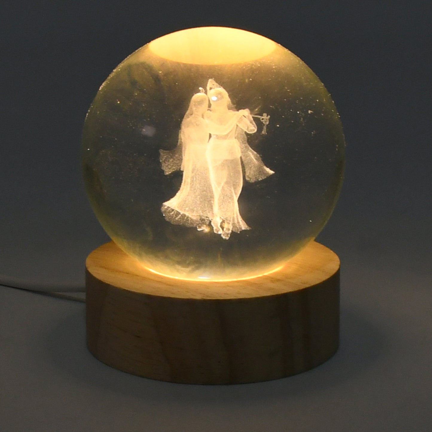 3D crystal ball lamp for bedroom featuring an illuminated dancing couple design on a wooden base