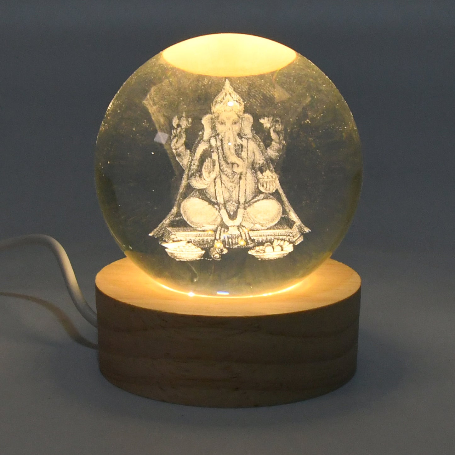 3D crystal ball lamps for bedroom featuring an intricate design of Ganesh on a wooden base