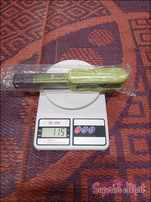 Green kitchen scale with a digital display on a patterned surface