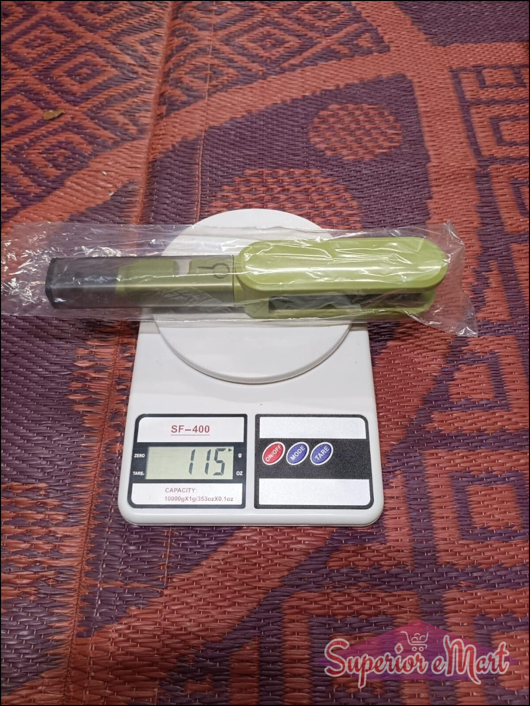 Green kitchen scale with a digital display on a patterned surface