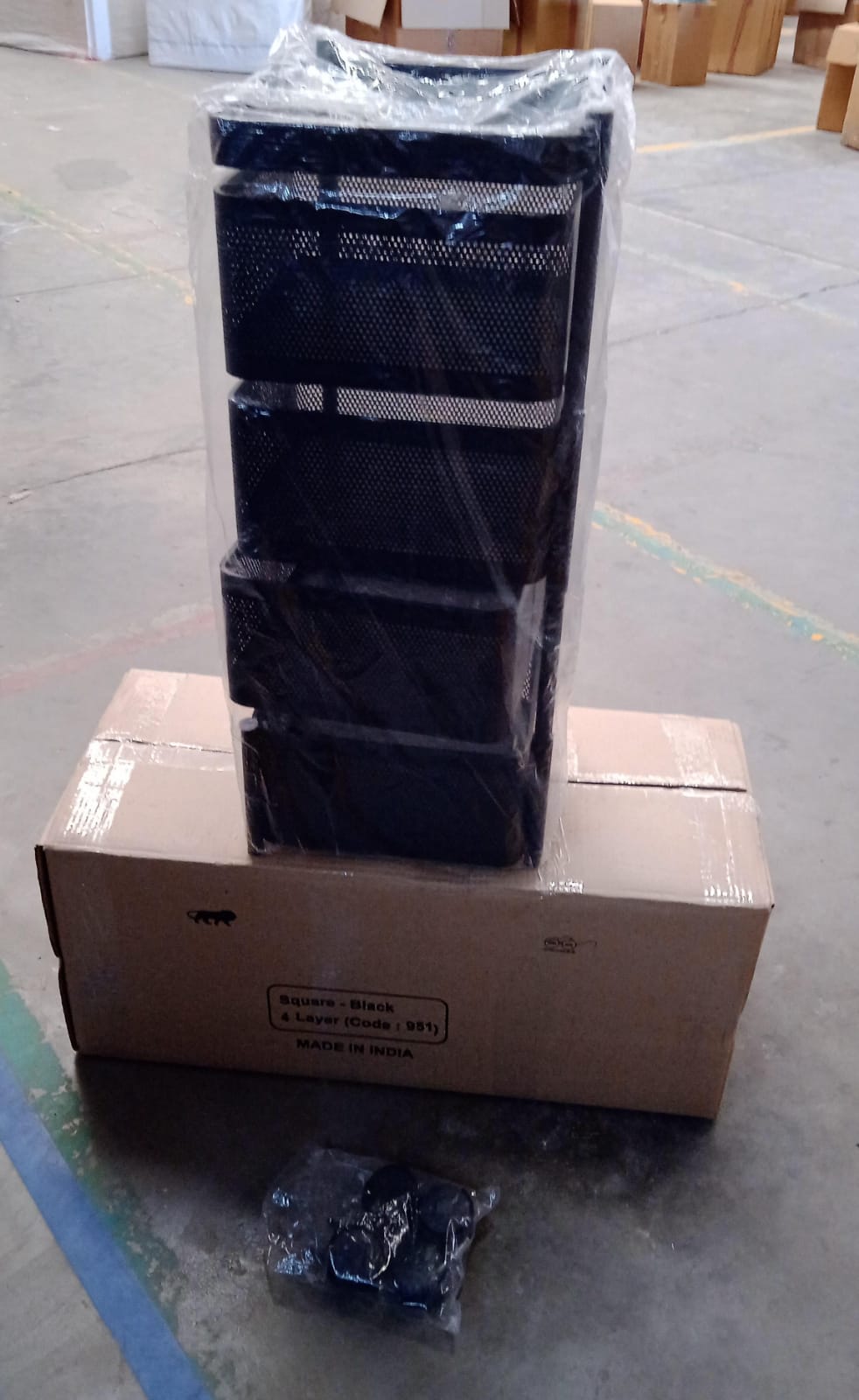 Superior eMart black 4 layer kitchen storage cart wrapped in plastic on top of a cardboard box