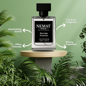 Nemat Sauvage Premium 50ml glass perfume bottle on a wood stand with green plants. 6-8hr longevity, office friendly.