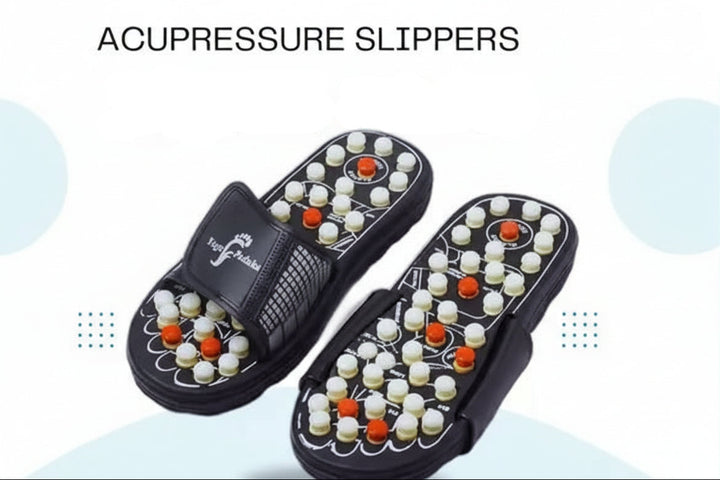 Acupressure slippers with black straps and textured footbeds covered in white and orange massage beads, shown on a light blue and white promotional background with text reading 'ACUPRESSURE SLIPPERS MEGA SALE' and contact details.