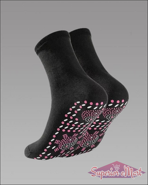 Pair of black knit mid-calf socks with pink and white non-slip grip dots on the soles.