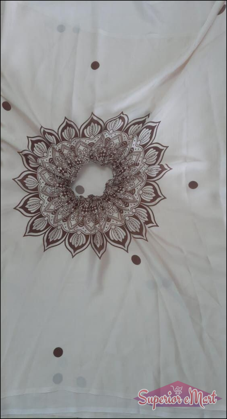 Off-white garment with a brown mandala print around a gathered neck and scattered brown polka dots.