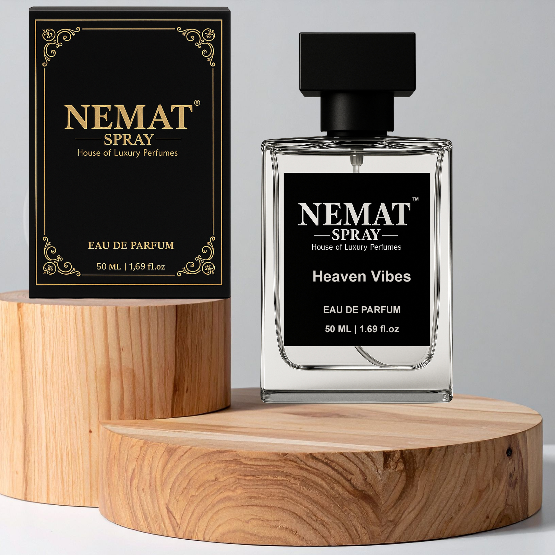 Nemat Heaven Vibes 50ml Eau de Parfum: clear glass bottle and black/gold box on round wooden display stands.