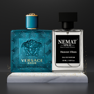 Versace Eros teal glass bottle and Nemat Heaven Vibes clear spray on a white marble stand with gold glitter.