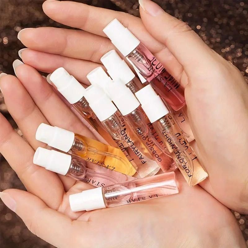 Hands holding 8 Perfumes Gift Box set of small sample perfume spray vials in assorted scents