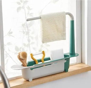 Adjustable sink organizer with compartments for brush, sponge, and towel holder in green and white
