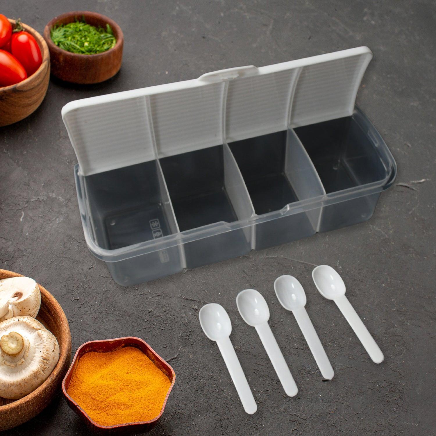 Airtight kitchen storage container with divided sections and measuring spoons for organizing spices