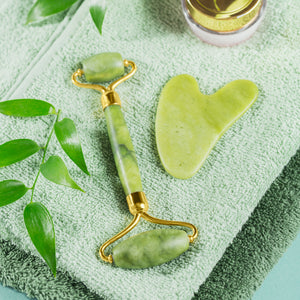 Superior eMart anti-aging face massager set with jade roller and gua sha tool on green towels
